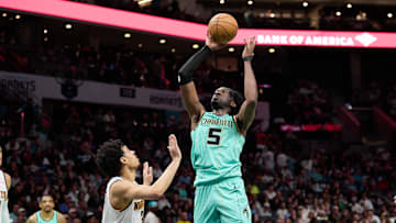 Feb 1, 2025; Charlotte, North Carolina, USA; Charlotte Hornets center Mark Williams (5) shoots over Denver Nuggets guard Julian Strawther (3) during the second half of play at Spectrum Center. Mandatory Credit: Brian Westerholt-Imagn Images