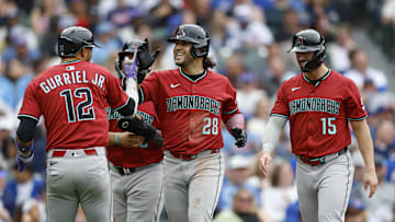 Apr 18, 2025; Chicago, Illinois, USA; Arizona Diamondbacks third baseman Eugenio Suarez (28) celebrates with teammates after hitting a grand slam against the Chicago Cubs during the eight inning at Wrigley Field. Mandatory Credit: Kamil Krzaczynski-Imagn Images