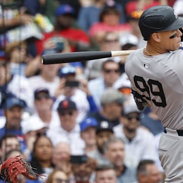 Sep 6, 2024; Chicago, Illinois, USA; New York Yankees outfielder Aaron Judge (99) hits an RBI-double against the Chicago Cubs during the third inning at Wrigley Field. Mandatory Credit: Kamil Krzaczynski-Imagn Images