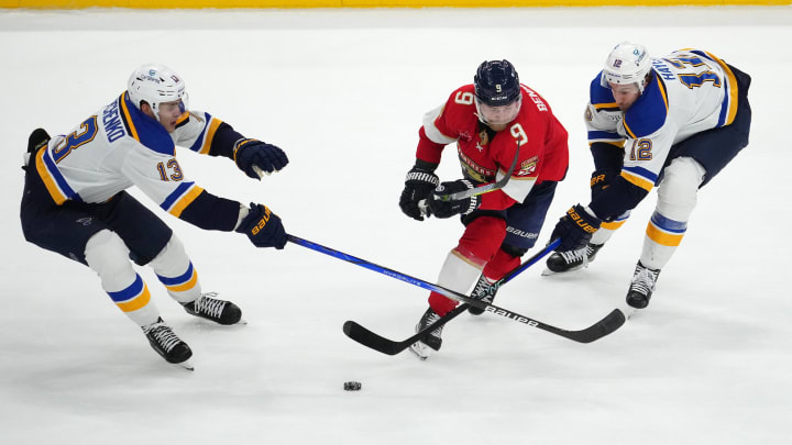 Dec 21, 2023; Sunrise, Florida, USA; Florida Panthers center Sam Bennett (9) skates between St. Louis Blues right wing Alexey Toropchenko (13) and right wing Kevin Hayes (12) during the second period at Amerant Bank Arena. Mandatory Credit: Jasen Vinlove-USA TODAY Sports