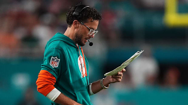 Miami Dolphins head coach Mike McDaniel looks over his play card 