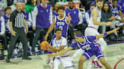 TCU's David Punch and Brendan Wenzel defend the basket in the Horned Frogs' loss last week to the Kansas Jayhawks.