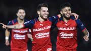 Jugadores de Chivas celebran un gol.