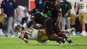 Oct 7, 2023; Miami Gardens, Florida, USA; Miami Hurricanes safety Kamren Kinchens (5) tackles Georgia Tech Yellow Jackets quarterback Haynes King (10) in the first half at Hard Rock Stadium. Mandatory Credit: Jasen Vinlove-USA TODAY Sports