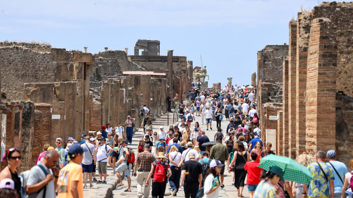 Crowd of tourists on the main street of the Pompeii...