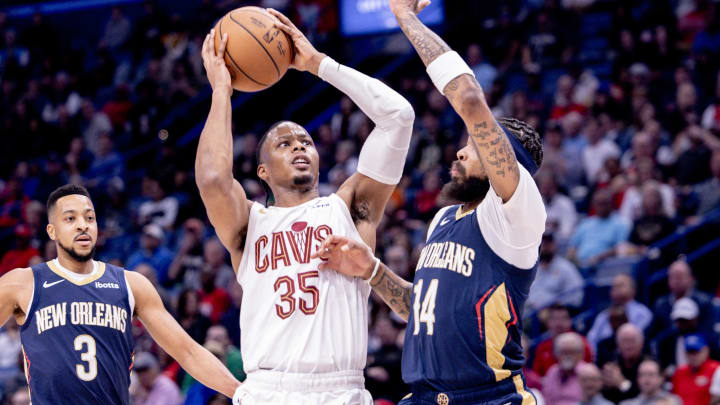 Mar 13, 2024; New Orleans, Louisiana, USA; Cleveland Cavaliers forward Isaac Okoro (35) shoots a jump shot against New Orleans Pelicans forward Brandon Ingram (14) during the first half at Smoothie King Center. Mandatory Credit: Stephen Lew-USA TODAY Sports