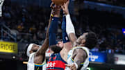 Nov 24, 2024; Indianapolis, Indiana, USA; Washington Wizards center Jonas Valanciunas (17) fights for a rebound between Indiana Pacers forward Jarace Walker (5) and  guard Bennedict Mathurin (00) in the second half at Gainbridge Fieldhouse. Mandatory Credit: Trevor Ruszkowski-Imagn Images