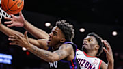 Dec 30, 2024; Tucson, Arizona, USA; Arizona Wildcats forward Tobe Awaka (30) and TCU Horned Frogs reach for the ball during the first half of the game at McKale Center. Mandatory Credit: Aryanna Frank-Imagn Images