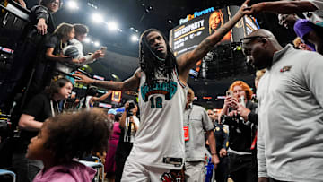 Grizzlies' Ja Morant (12) high fives fans as he walks off the court after the Grizzlies defeated the Mavericks 120-106 in the play-in game to secure a spot in the NBA Playoffs at FedExForum in Memphis, Tenn., on Friday, April 18, 2025.
