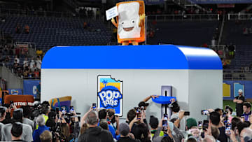 Dec 28, 2024; Orlando, FL, USA; The Cinnamon Pop-Tart mascot goes into a toaster to be toasted after the Iowa State Cyclones defeatied the Miami Hurricanes at Camping World Stadium. Mandatory Credit: Jasen Vinlove-Imagn Images