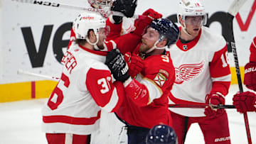 Jan 17, 2024; Sunrise, Florida, USA; Florida Panthers center Sam Bennett (9) and Detroit Red Wings right wing Christian Fischer (36) exchange jabs while in a scrum during the first period at Amerant Bank Arena. Mandatory Credit: Jasen Vinlove-Imagn Images