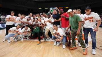 Feb 6, 2023; Coral Gables, Florida, USA; Miami Marlins centerfielder Jazz Chisholm Jr., outfielder Avisail Garcia, outfielder Jorge Soler, and coach Jon Jay pose on the court with members of the Miami Hurricanes baseball team during the second half between the Miami Hurricanes and the Duke Blue Devils at Watsco Center. Mandatory Credit: Jasen Vinlove-USA TODAY Sports