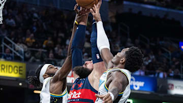 Nov 24, 2024; Indianapolis, Indiana, USA; Washington Wizards center Jonas Valanciunas (17) fights for a rebound between Indiana Pacers forward Jarace Walker (5) and  guard Bennedict Mathurin (00) in the second half at Gainbridge Fieldhouse. Mandatory Credit: Trevor Ruszkowski-Imagn Images