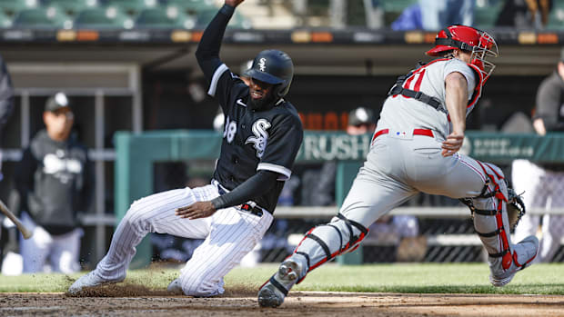 Chicago White Sox center fielder Luis Robert Jr. scores against Philadelphia Phillies catcher J.T. Realmuto.