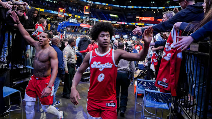 Grizzlies' Desmond Bane (22) and Jaylen Wells (0) high five fans after the Grizzlies defeated the Pelicans 139-126 at FedExForum on Friday, January 24, 2025, in Memphis, Tenn.