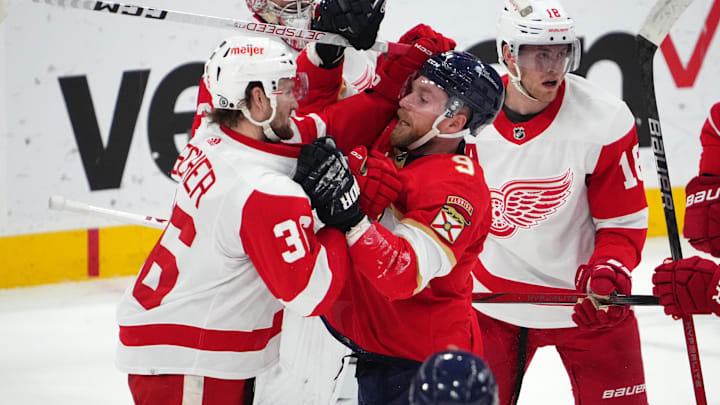 Jan 17, 2024; Sunrise, Florida, USA; Florida Panthers center Sam Bennett (9) and Detroit Red Wings right wing Christian Fischer (36) exchange jabs while in a scrum during the first period at Amerant Bank Arena. Mandatory Credit: Jasen Vinlove-Imagn Images