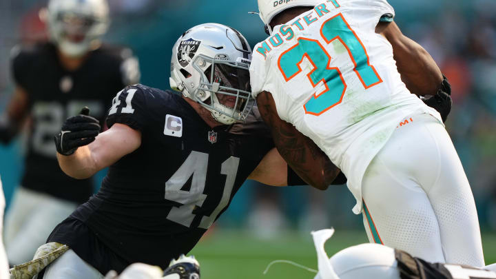 Nov 19, 2023; Miami Gardens, Florida, USA; Las Vegas Raiders linebacker Robert Spillane (41) tackles Miami Dolphins running back Raheem Mostert (31) during the first half at Hard Rock Stadium. Mandatory Credit: Jasen Vinlove-USA TODAY Sports