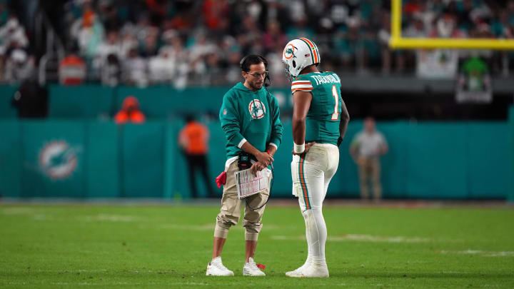 Dec 24, 2023; Miami Gardens, Florida, USA; Miami Dolphins head coach Mike McDaniel talks with quarterback Tua Tagovailoa (1) during a timeout in the second half against the Dallas Cowboys at Hard Rock Stadium. Mandatory Credit: Jasen Vinlove-USA TODAY Sports