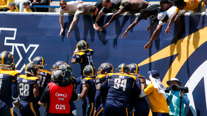 Showboats players run to celebrate with fans after they intercepted the ball during the UFL game between the San Antonio Brahmas and Memphis Showboats in Simmons Bank Liberty Stadium in Memphis, Tenn., on Saturday, April 6, 2024.