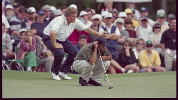 Tiger Woods lines up putt with Colin Montgomerie behind him at the Augusta National Golf Course during the 1997 Masters.