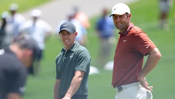 Rory McIlroy and Scottie Scheffler watch Xander Schauffele putt during the first round of the 2025 PGA Championship