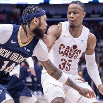 Mar 13, 2024; New Orleans, Louisiana, USA; New Orleans Pelicans forward Brandon Ingram (14) dribbles against Cleveland Cavaliers forward Isaac Okoro (35) during the second half at Smoothie King Center.