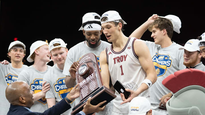 Trojans Thomas Dowd (1) is handed the trophy following their 77-61 victory over the Eagles during the Georgia Southern vs Troy men’s Sun Belt Conference Championship basketball game at the Pensacola Bay Center in Pensacola, Florida on March 9, 2026.