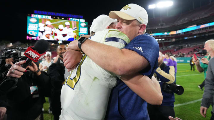 Dec 22, 2023; Tampa, FL, USA; Georgia Tech Yellow Jackets quarterback Haynes King (10) hugs head coach Brent Key after defeating UCF Knights in the Gasparilla Bowl at Raymond James Stadium