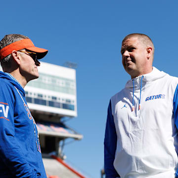 Apr 12, 2025; Gainesville, FL, USA; Florida Gators athletic director Scott Stricklin, seen in a Florida Victorious long sleeve, and Florida Gators head coach Billy Napier talk before the game at Ben Hill Griffin Stadium. Mandatory Credit: Matt Pendleton-Imagn Images
