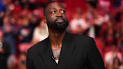 Jan 14, 2024; Miami, Florida, USA; Former Miami Heat player Dwayne Wade reacts after learning a statue will be erected outside of Kaseya Center in 2025, during a special ceremony during halftime of the game between the Miami Heat and the Charlotte Hornets. Mandatory Credit: Jasen Vinlove-Imagn Images