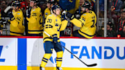 Feb 12, 2025; Montreal, Quebec, CAN; [Imagn Images direct customers only] Team Sweden forward Joel Eriksson (20) celebrates with teammates at the bench after scoring against Team Canada in the third period during a 4 Nations Face-Off ice hockey game at Bell Centre. Mandatory Credit: David Kirouac-Imagn Images