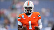 Dec 28, 2024; Orlando, FL, USA; Miami Hurricanes quarterback Cam Ward (1) warms up prior to the game against the Iowa State Cyclones at Camping World Stadium. Mandatory Credit: Jasen Vinlove-Imagn Images