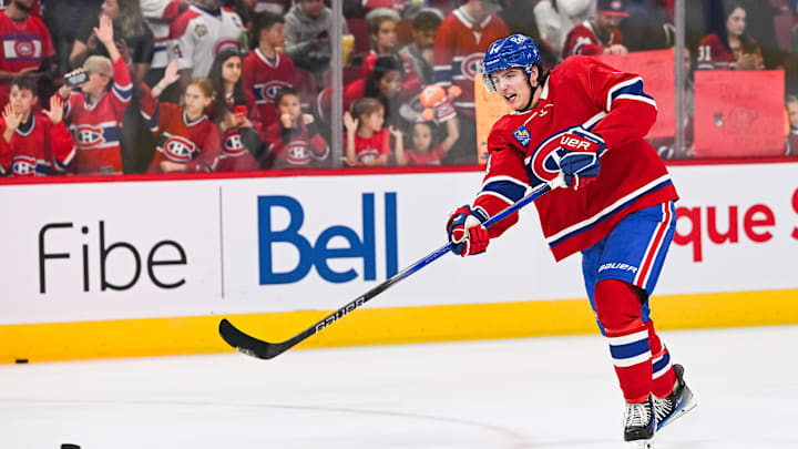 Sep 30, 2023; Montreal, Quebec, CAN; Montreal Canadiens defenseman David Reinbacher (64) shoots a puck during warm-up before the game against the Toronto Maple Leafs at Bell Centre. Mandatory Credit: David Kirouac-Imagn Images