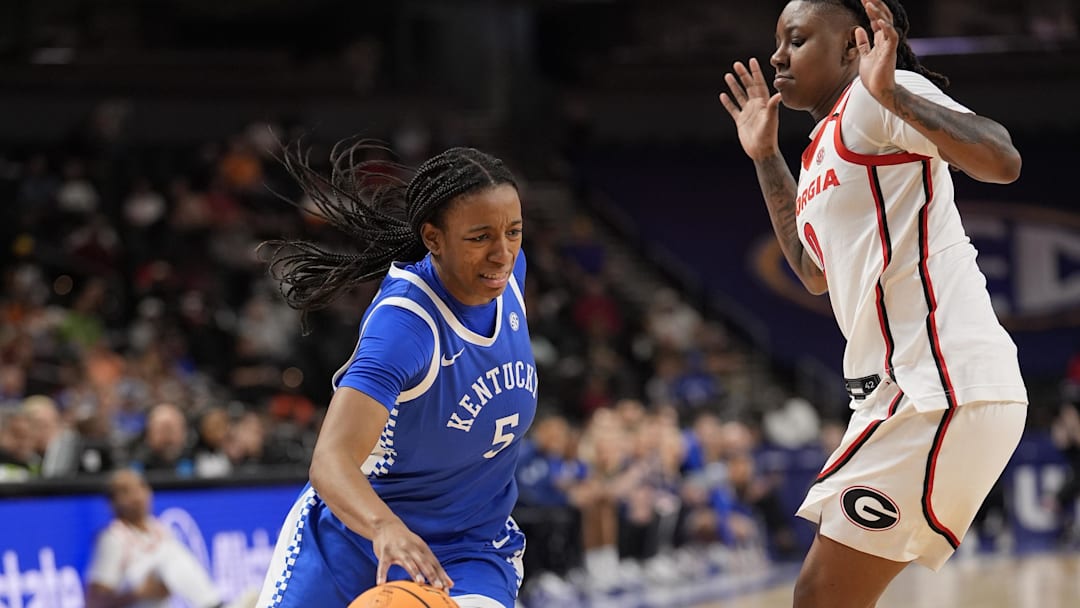 Mar 5, 2026; Greenville, SC, USA; Kentucky Wildcats guard Tonie Morgan (5) drives to the basket against Georgia Bulldogs guard Trinity Turner (0) during the first half at Bon Secours Wellness Arena. Mandatory Credit: Jim Dedmon-Imagn Images
