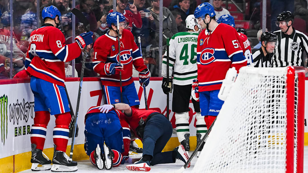 Nov 13, 2025; Montreal, Quebec, CAN; Montreal Canadiens center Alex Newhook (15) lays on the ice after being injured against the Dallas Stars during the second period at Bell Centre. Mandatory Credit: David Kirouac-Imagn Images