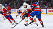 Dec 3, 2024; Montreal, Quebec, CAN; Montreal Canadiens defenseman Mike Matheson (8) defends the puck against New York Islanders center Kyle Palmieri (21) during the second period at Bell Centre. Mandatory Credit: David Kirouac-Imagn Images