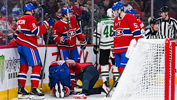 Nov 13, 2025; Montreal, Quebec, CAN; Montreal Canadiens center Alex Newhook (15) lays on the ice after being injured against the Dallas Stars during the second period at Bell Centre. Mandatory Credit: David Kirouac-Imagn Images