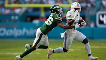 Dec 8, 2024; Miami Gardens, Florida, USA; New York Jets cornerback Brandin Echols (26) attempts to tackle Miami Dolphins wide receiver Tyreek Hill (10) during the first half at Hard Rock Stadium. Mandatory Credit: Jasen Vinlove-Imagn Images