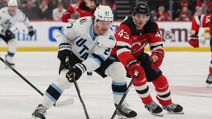 Utah Mammoth center Barrett Hayton (27) skates with the puck as New Jersey Devils defenseman Luke Hughes (43) during the first period at Prudential Center. Mandatory Credit: Ed Mulholland-Imagn Images
