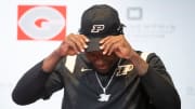 Germantown   s D.J. Allen puts on his Purdue hat during the signing ceremony on National Signing Day