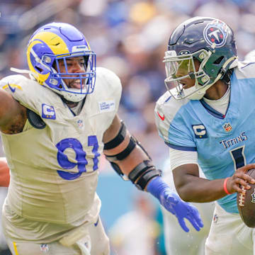 Tennessee Titans quarterback Cam Ward (1) evades Los Angeles Rams defensive end Kobie Turner (91) during the fourth quarter at Nissan Stadium on Sunday, Sept. 14. Ward, a former Columbia High School standout out of Texas and the top overall NFL Draft pick, recorded his first career touchdown pass