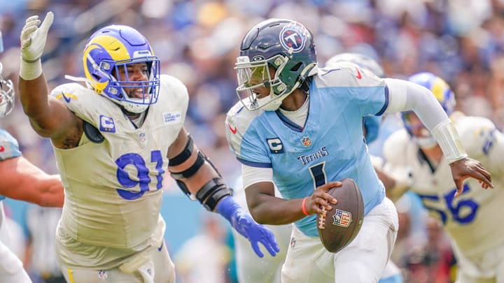 Tennessee Titans quarterback Cam Ward (1) evades Los Angeles Rams defensive end Kobie Turner (91) during the fourth quarter at Nissan Stadium on Sunday, Sept. 14. Ward, a former Columbia High School standout out of Texas and the top overall NFL Draft pick, recorded his first career touchdown pass