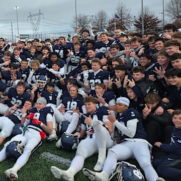 The Lake Oswego football team celebrates after winning the Class 6A state championship Friday afternoon.