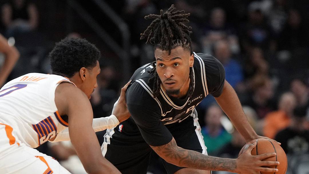 Oct 10, 2026; Phoenix, Arizona, USA; San Antonio Spurs guard Stephon Castle (5) shields the ball from Phoenix Suns forward Ryan Dunn (0) in the second half at Mortgage Matchup Center.
