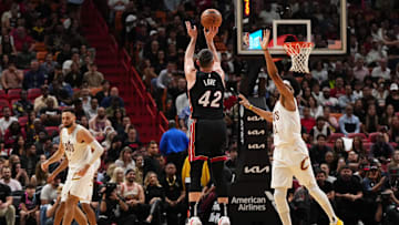 Dec 8, 2023; Miami, Florida, USA; Miami Heat forward Kevin Love (42) attempts a three point shot over Cleveland Cavaliers center Jarrett Allen (31) during the second half at Kaseya Center. Mandatory Credit: Jasen Vinlove-Imagn Images