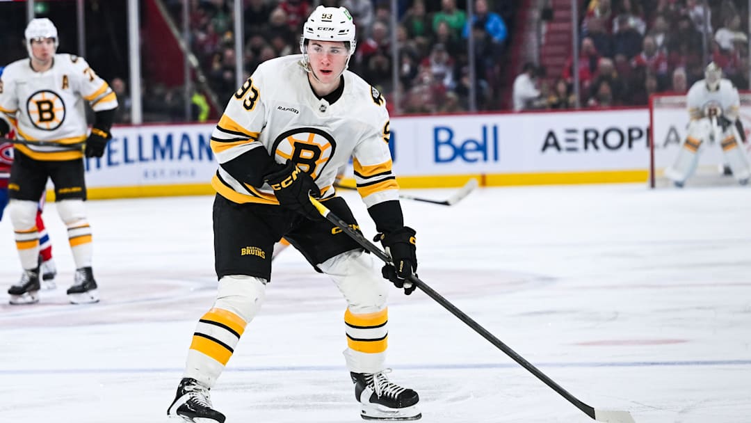 Mar 17, 2026; Montreal, Quebec, CAN; Boston Bruins center Fraser Minten (93) plays the puck against the Montreal Canadiens during the third period at Bell Centre. Mandatory Credit: David Kirouac-Imagn Images