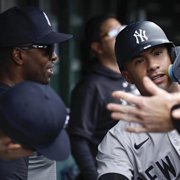 Sep 6, 2024; Chicago, Illinois, USA; New York Yankees second baseman Gleyber Torres (25) celebrates with teammates in the dugout after scoring against the Chicago Cubs during the third inning at Wrigley Field.