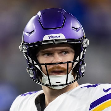 Jan 13, 2025; Glendale, AZ, USA; Minnesota Vikings quarterback Sam Darnold (14) against the Los Angeles Rams during an NFC wild card game at State Farm Stadium. Mandatory Credit: Mark J. Rebilas-Imagn Images