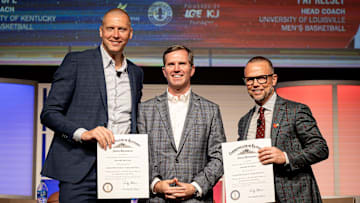 Kentucky Governor Andy Beshear, center, posed for a photo onstage after giving Kentucky basketball coach Mark Pope and Louisville basketball coach Pat Kelsey the title of Kentucky Colonel at the 2024 Leadership Louisville Luncheon at the Kentucky International Convention Center in downtown Louisville on Wednesday, August 28, 2024.