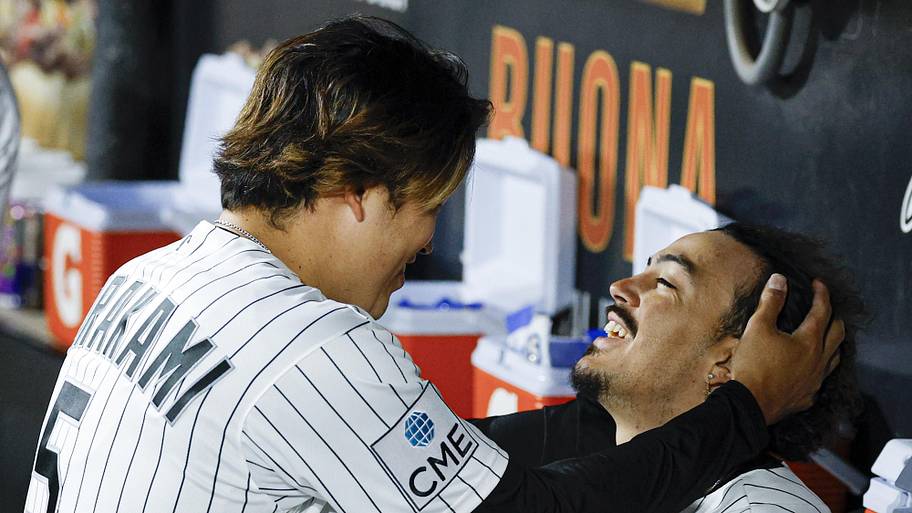 Chicago White Sox first baseman Munetaka Murakami (left) jokes with third baseman Miguel Vargas in the dugout